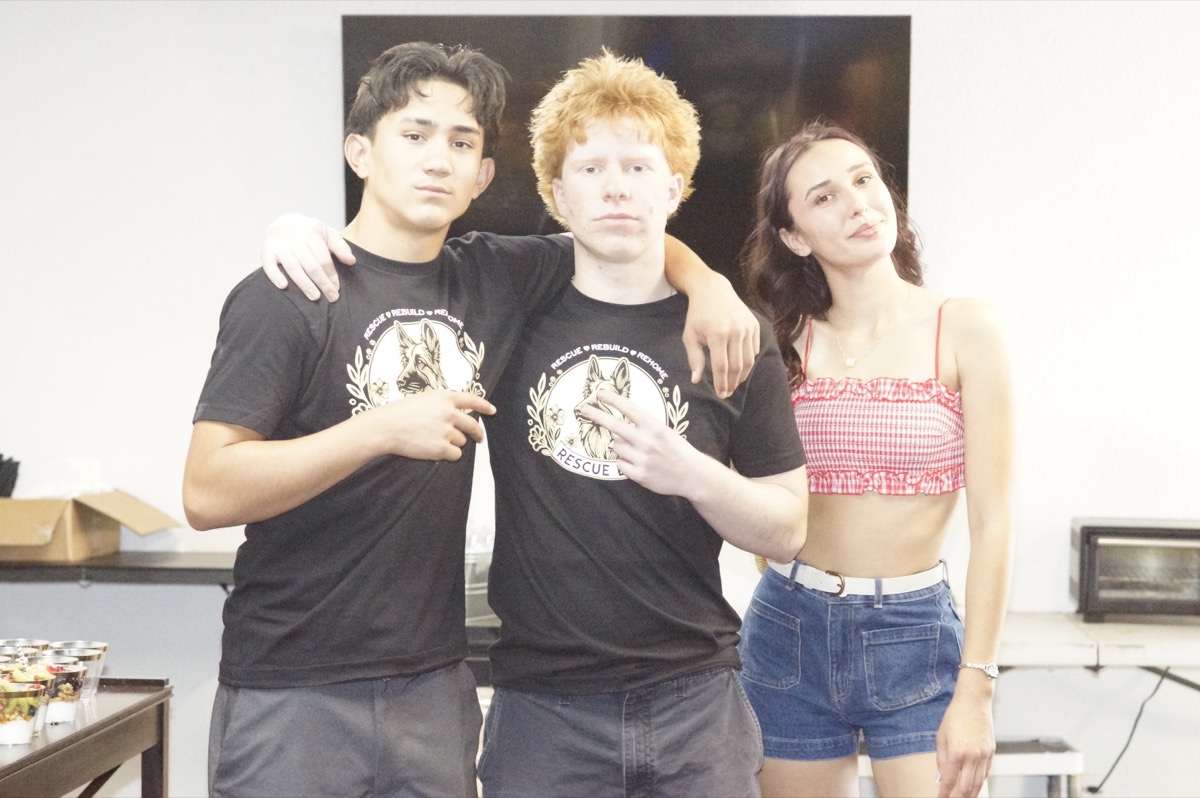 Three young volunteers in Rescue, Rebuild, Rehome shirts